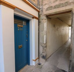 A doorway with number 21A and a pathway at 21A High Street Jedburgh