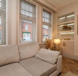 A living room with a sofa and decorative shelves at 59 Moorland Road Scarborough