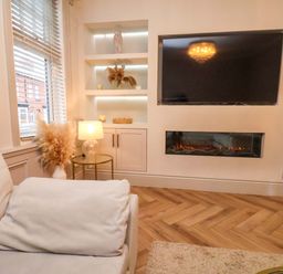 A living room with a television and fireplace at 59 Moorland Road Scarborough
