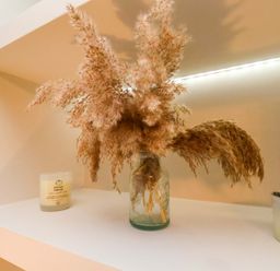A shelf with pampas grass in a vase and candles at 59 Moorland Road Scarborough