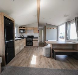 A kitchen with appliances and dining area at Billy’s Way - Hayling Island