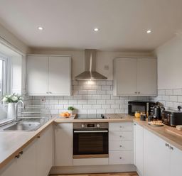 A kitchen with appliances and food items at Ty Golau in Llanbedrog