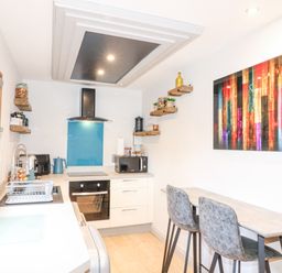 A kitchen with countertops stove oven microwave and two chairs at Orchard Retreat Staycation in Kirton