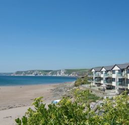A beach with a building and ocean view at Apartment 12, Burgh Island Causeway Bigbury-On-Sea