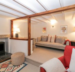 A living room with sofas lamps a small fireplace and a patterned rug at Springfield in Kingsand