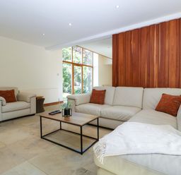 A living room with a sofa and coffee table at Heathcliffe House, Castleton near Cardiff