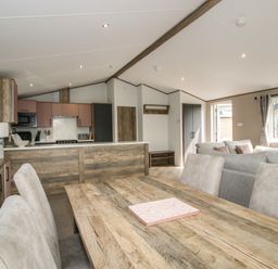 A dining area and kitchen with seating at Peony in Eardisland