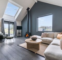 A living room with a sofa and coffee table at Grove Cottage in Gladestry