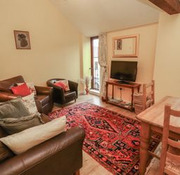 A living room with a tv and sofa at The Hayloft near Wigton