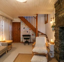 A living room with a sofa and fireplace at Waterfall Retreat in Blaenau Ffestiniog