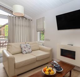 A living room with a sofa and coffee table at Newton Calm in Newton Ferrers