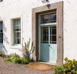 A door with windows and plants at Cheviot Manor in Akeld near Wooler