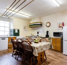 A kitchen with a table and chairs at Cheviot Manor near Wooler