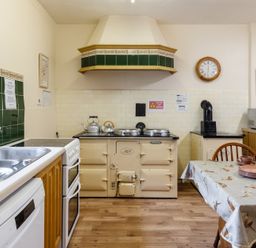 A kitchen with a stove and table at Cheviot Manor Akeld near Wooler