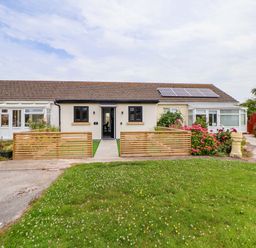 A house with a front door, windows, and garden at 4 Willow Grove - Freehold in Talacre