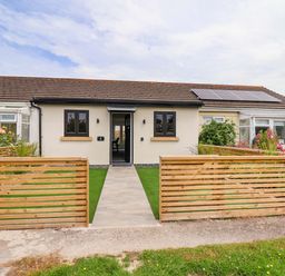 A house with a pathway and garden at 4 Willow Grove in Talacre