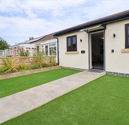 An entrance with a pathway and lawn at 4 Willow Grove - Freehold Talacre
