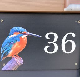 A black house number sign with number 36 and a colorful kingfisher bird at Lodge 36 - Kingfisher Lodge in Wickhamford near Evesham