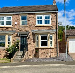 A house with multiple windows and garage at Harefield in Rothbury