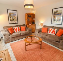 A living room with two sofas and a coffee table at Sea View Loft in Rosudgeon