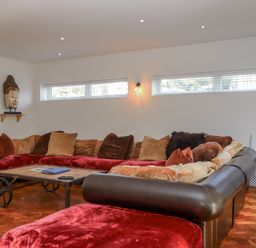 A living room with a large sofa and a table at Delmonte Lodge in Torquay