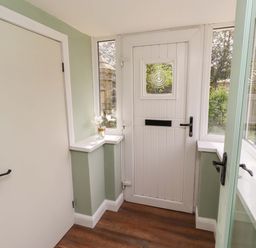 A hallway with a door and windows at The Lodge in Powburn