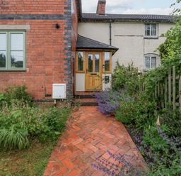 The entrance of a house with a path and garden at 2 Loxter Villas Wellington Heath near Ledbury