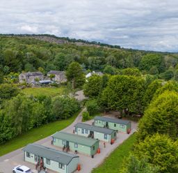 A view of cabins and trees near a railway at Lodge 2 Silverdale
