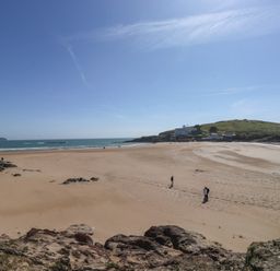 A beach with people walking and cliffs in the background at 6 Burgh Island Bigbury-On-Sea