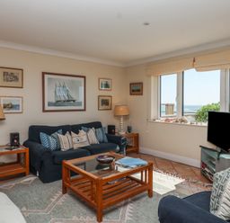A living room with a sofa and coffee table at 6 Burgh Island in Bigbury-On-Sea