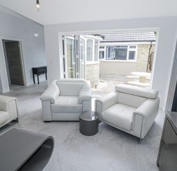 A living room with armchairs and a coffee table at Chillon South Littleton near Honeybourne