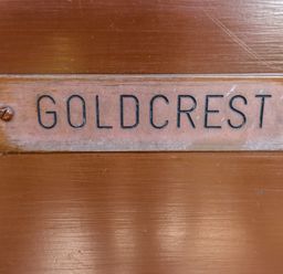 A wooden plaque with the word goldcrest attached to a wooden surface at Goldcrest in Withern near Alford