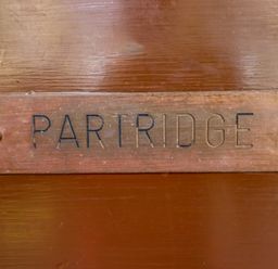 A close up of a plaque with the word Partridge on a wooden surface at Partridge in Withern near Alford