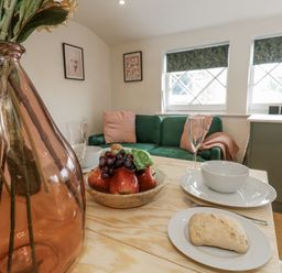 A living room with a fruit bowl and vase at Sea Pink Studio Swanage