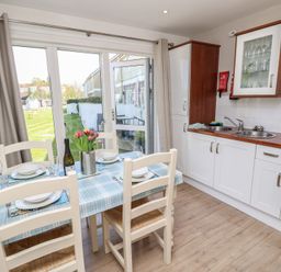 A kitchen with a dining table and view of the outdoor area at Plimoth N8 Yarmouth