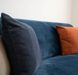 A close up of cushions on a blue sofa at The Cove in Kessingland