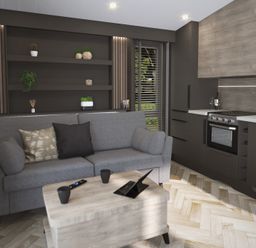 A living area with a grey sofa and cushions a wooden coffee table with mugs and a tablet a kitchen area with dark cabinets an oven and countertop with bread and wine at Elter Luxury Pod in Keswick