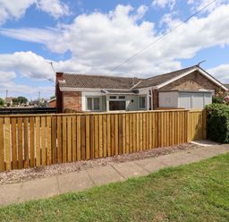 A house with a fence and garage at North Sands in Beadnell