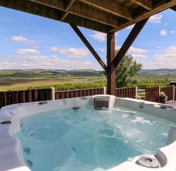 A hot tub with a scenic view at Llwyngwinau Isaf Barn in Tynreithyn near Tregaron