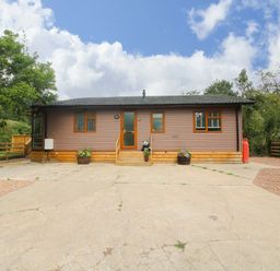 A house with a driveway and plants at Dunromin Montgomery
