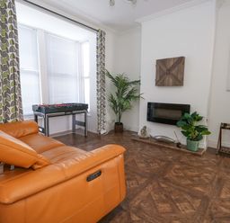 A living room with a foosball table and a plant at Weymouth Seaside House in Weymouth