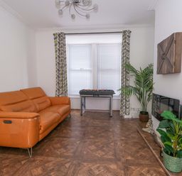 A living room with a sofa, foosball table and plants at Weymouth Seaside House in Weymouth