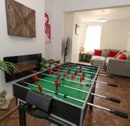 A living room with foosball table and sofa at Weymouth Seaside House in Weymouth