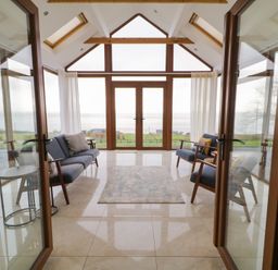 A conservatory with seating and a view at Ard Na Mara, Drung near Quigley's Point, County Donegal