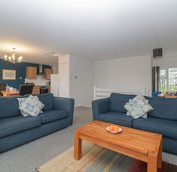 A living room with two blue sofas and a wooden coffee table at Tamar Cottages 34 St Ann's Chapel Cornwall