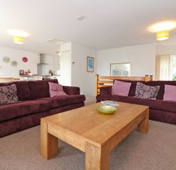 A living room with two maroon sofas and a wooden coffee table at Tamar Cottages 35 in St Ann's Chapel Cornwall