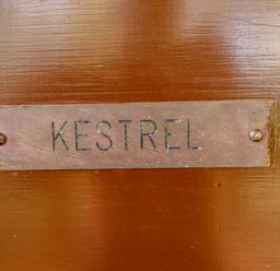 A metal nameplate with the word KESTREL mounted on a wooden surface at Kestrel in Withern near Alford