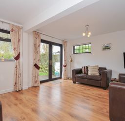 A living room with sofas and a television at Kernyk in Camelford