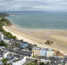 A coastal town with buildings along a sandy beach and the sea at No 10 Croft House in Tenby