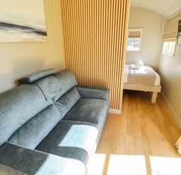 A living room with a sofa and a bed at Magnolia in Grimsby